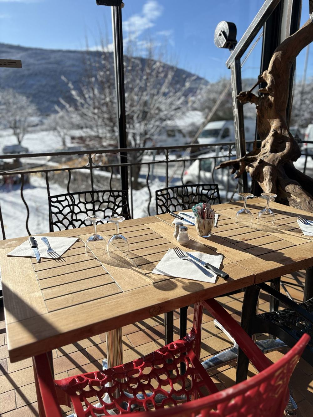 The terrace laid for service, facing the snow-covered mountain